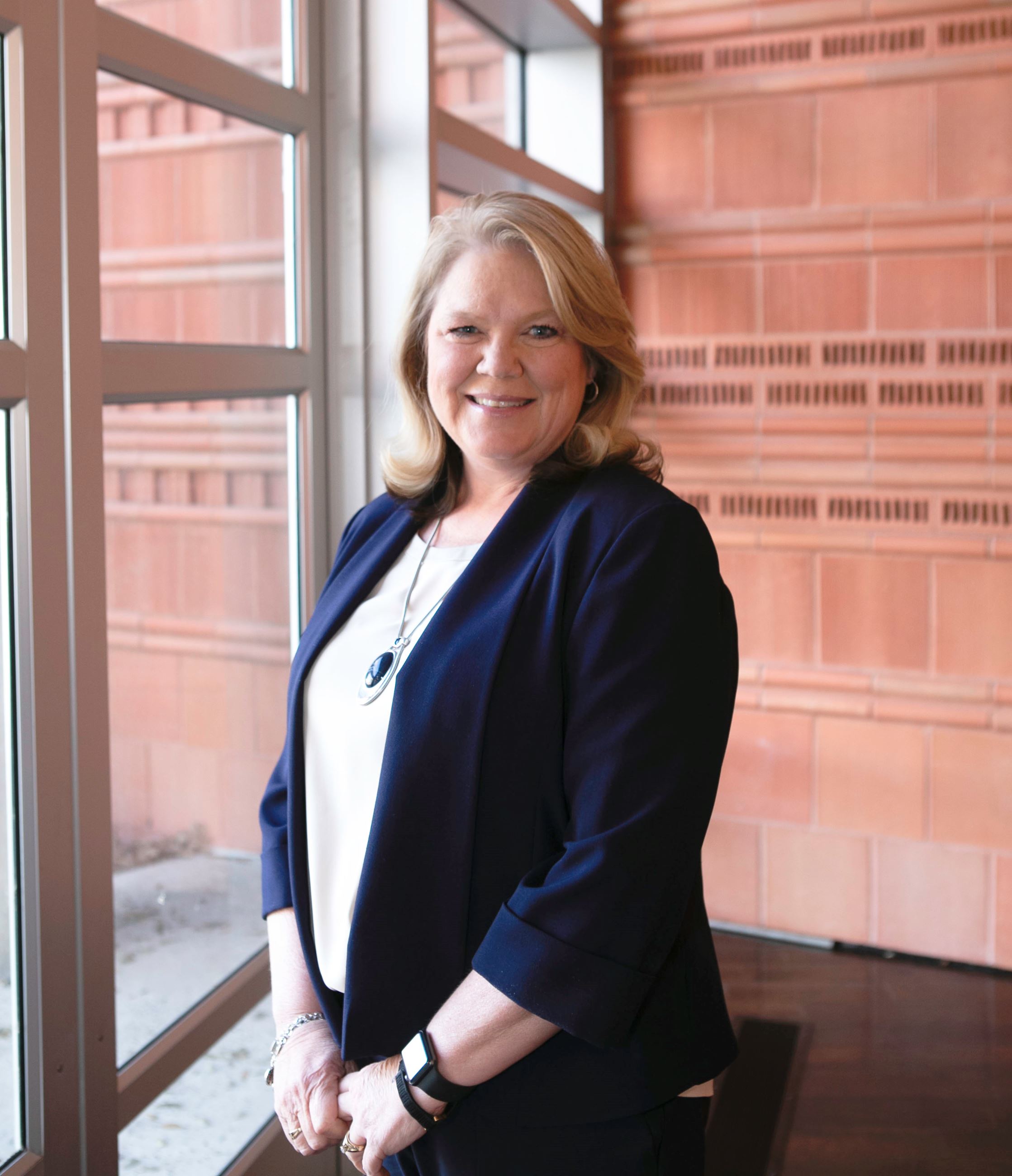 Woman standing in front of window facing camera
